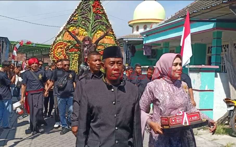 Ratusan warga Dusun Kletak, Desa Putatlor, Kecamatan Menganti, Kabupaten Gresik, Jawa Timur, Arak Gunungan Hasil Bumi Sabtu siang( 3/8)