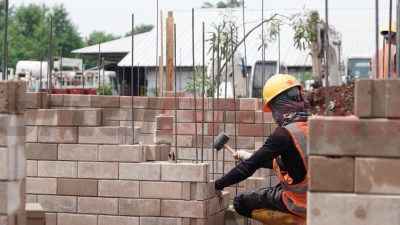 Proses pemasangan produk turunan semen hijau SIG bata interlock presisi untuk pembangunan rumah contoh di kawasan Bambu Apus, Jakarta Timur